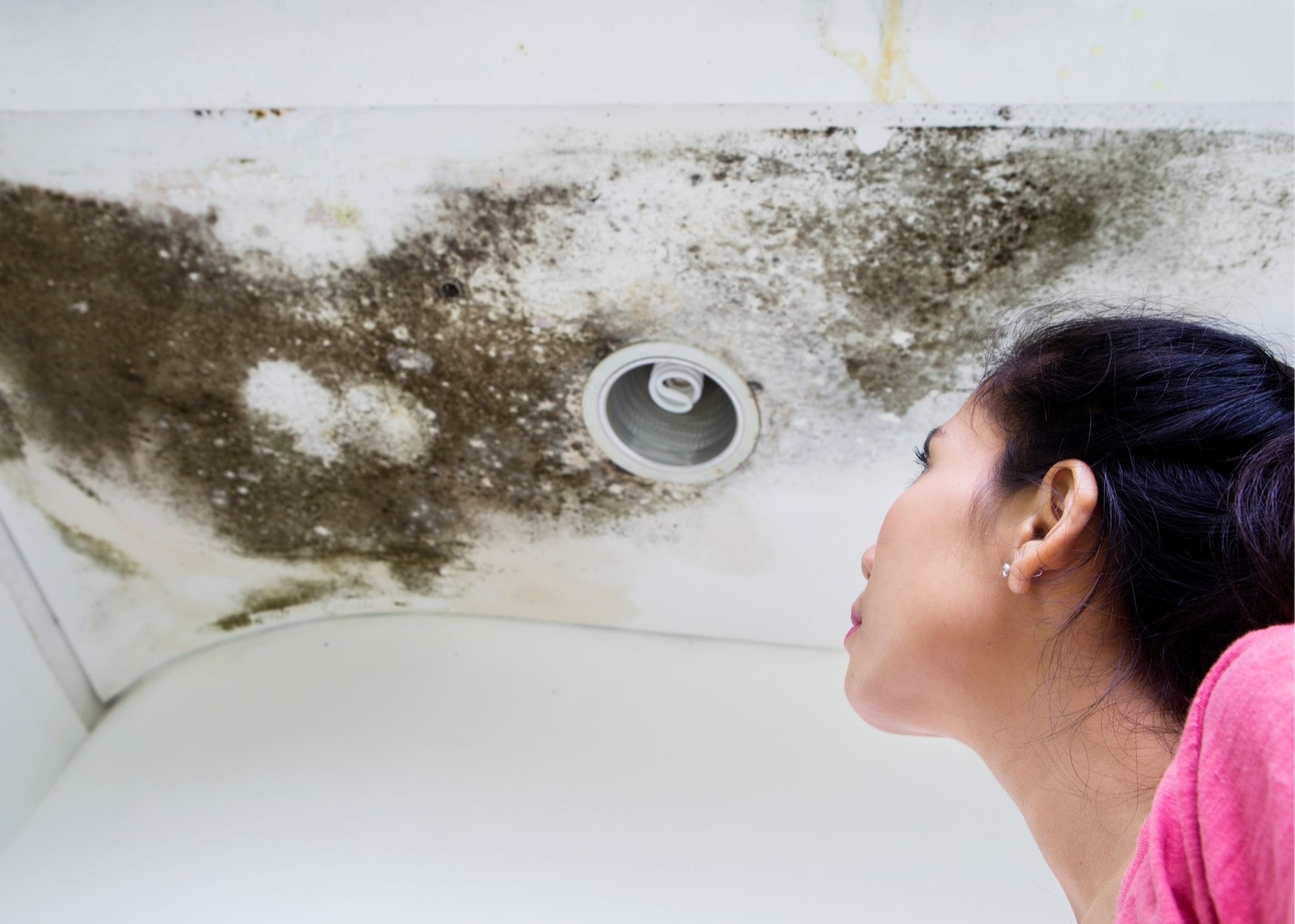 Mold growth around a bathroom ceiling vent in an Overland Park home