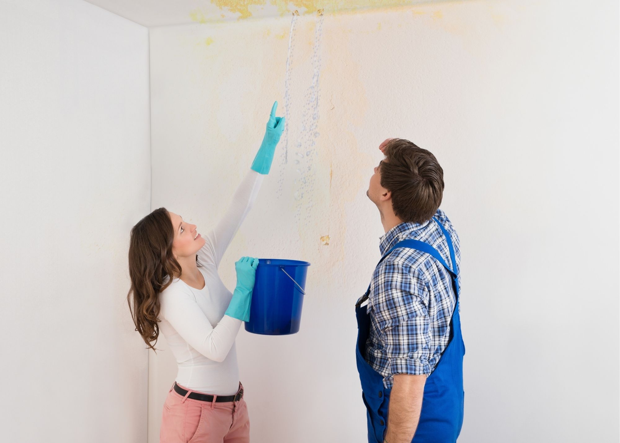Technician discussing a ceiling leak repair with an Overland Park homeowner