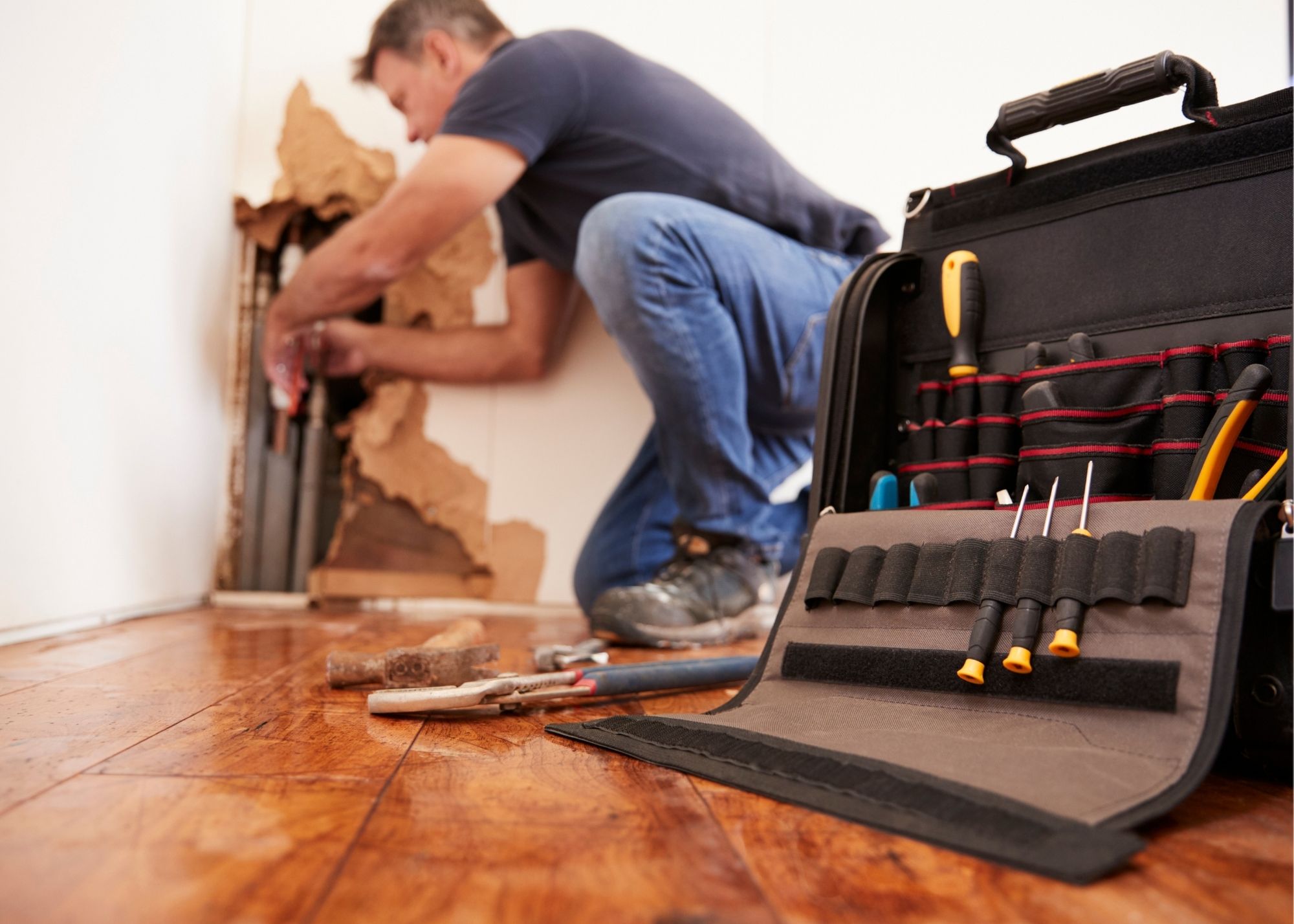 Restoration technician placing drying equipment in an Overland Park home